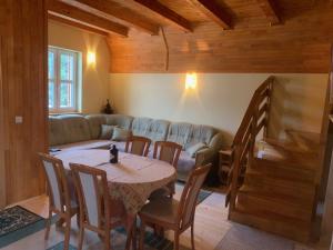 a living room with a table and a couch at Vikendica PEPO in Blidinje