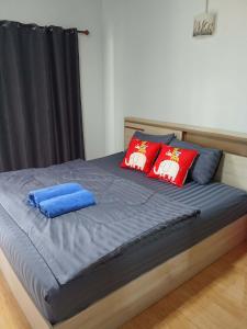 a bed with red and blue pillows on it at A Nature House in Ko Lanta Yai