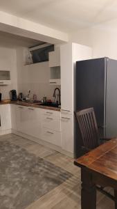 a kitchen with a wooden table and a refrigerator at Wohnung für 7 Personen in Hückelhoven