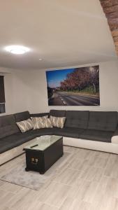 a living room with a black couch and a tv at Wohnung für 7 Personen in Hückelhoven