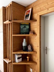 a wooden wall with shelves in a room at Beautiful mountain apartment in Leysin