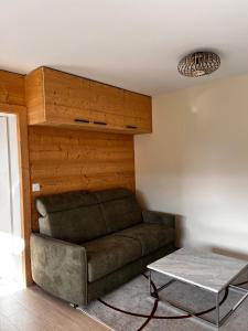 a living room with a couch and a table at Beautiful mountain apartment in Leysin