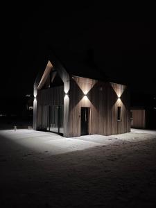 a building with lights on the side of it at night at Stodoła Na Widoku z Balią in Radków