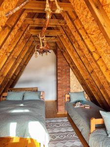 a bedroom with two beds in a attic at Vikendica Pino in Han Pijesak