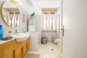 a bathroom with a sink and a mirror and a toilet at La casa di Nirvana in Bracciano +42 photos