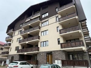a building with cars parked in front of it at The View Studio 2 Busteni in Buşteni