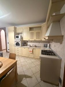a kitchen with white cabinets and a stove top oven at La Riviera in Mira