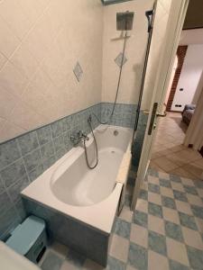a bath tub in a bathroom with a shower at La Riviera in Mira +2 photos