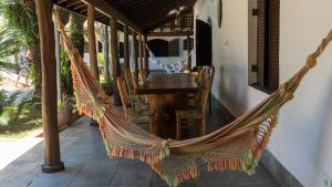 a hammock on the porch of a house at Casa Itaguá in Ubatuba