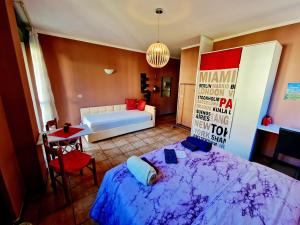 a bedroom with a bed and a couch and a table at Bernina Station Suite - 30 Steps to the Red Train in Tirano