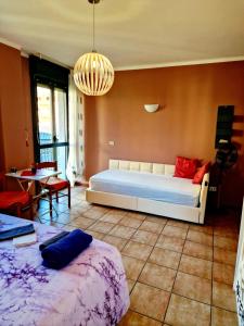 a bedroom with two beds and a chandelier at Bernina Station Suite - 30 Steps to the Red Train in Tirano +9 photos