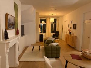 a living room with a couch and a table at Bed & Breakfast Anna in Groningen