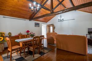 a dining room with a table and chairs at Rustic House - Eco Farm Living in Capelas +12 photos