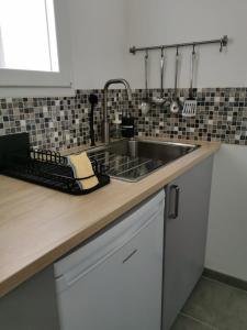 a kitchen with a sink and a counter top at maison de village in Renaison +19 photos
