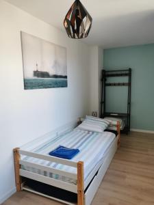 a bedroom with a bed and a picture on the wall at maison de village in Renaison