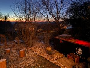 a hot tub and a bench with the sunset in the background at Chalupa pod Zubštejnem in Bystřice nad Pernštejnem +42 photos