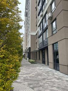 an empty sidewalk in front of a building at Central Park Apart Irpin in Irpin