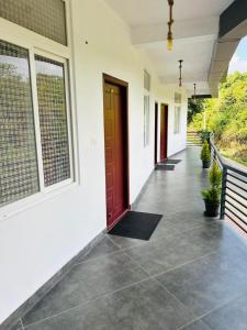 a hallway of a house with a red door at Breezy bluff in Madikeri