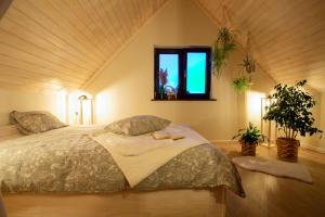 a bedroom with a large bed in a attic at Domki i tyle in Rabka-Zdrój