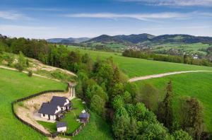 an aerial view of a house in a green field at Domki i tyle in Rabka-Zdrój +22 photos