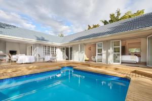 a swimming pool in the backyard of a house at Outeniqua Inn in George