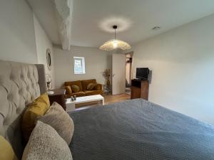 a bedroom with a bed and a living room at L'annexe in Venouse
