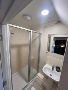 a bathroom with a shower and a sink at Siskin House in Wickham Market +35 photos