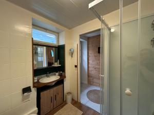 a bathroom with a sink and a shower at L'annexe in Venouse