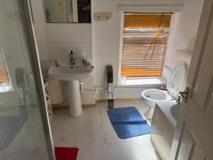 a small bathroom with a sink and a toilet at Treforest Cwtch House in Treforest