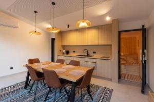 a kitchen with a wooden table and chairs at BLOK Wood Cottage in Visoko +6 photos