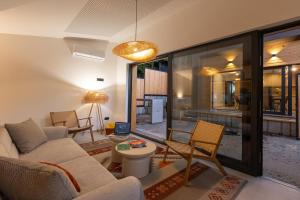 a living room with a couch and a table at BLOK Wood Cottage in Visoko
