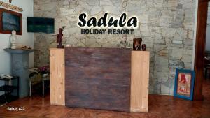 a sign that reads salula holiday resort on a stone wall at Sadula Holiday Resort in Anuradhapura