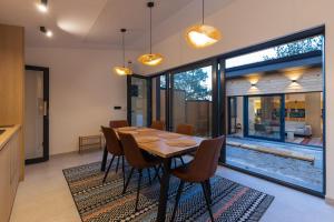 a dining room with a wooden table and chairs at BLOK Wood Cottage in Visoko