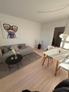 a living room with a couch and a table at Unique Living - Herning City Central House in Herning