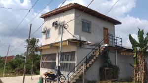 a house with a motorcycle parked in front of it at Casa do Will in Ananindeua