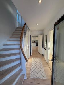 a hallway with a staircase in a house at Unique Living - Herning City Central House in Herning