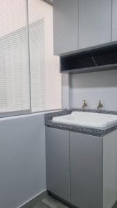 a bathroom with a white sink and a window at Mirador volcanes in Santa Luisa +5 photos
