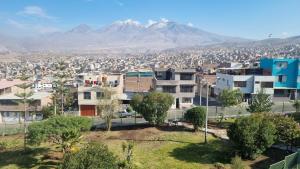a city with buildings and a mountain in the background at Mirador volcanes in Santa Luisa