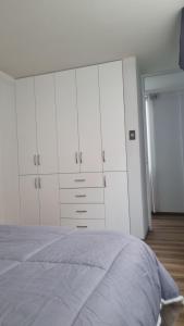 a bedroom with white cabinets and a bed at Mirador volcanes in Santa Luisa