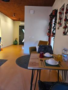 a living room with a table and chairs at Dolcevita guest house in Torreano