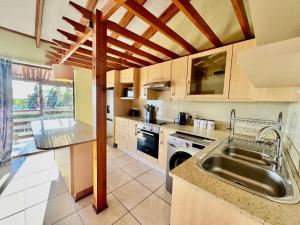 a kitchen with a sink and a counter top at Egret's Lookout in Cape Town