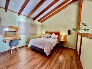a bedroom with a bed and a desk and a desk at Egret's Lookout in Cape Town +23 photos