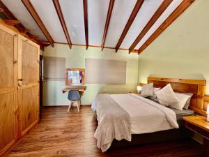 a bedroom with a bed and a desk in it at Egret's Lookout in Cape Town