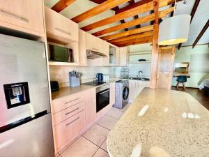 a kitchen with wooden ceilings and a counter top at Egret's Lookout in Cape Town