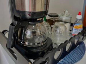 a black blender sitting on top of a stove at Recanto do Leste in Angra dos Reis +40 photos