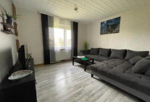 a living room with a couch and a table at Ferienhaus Seestern in Dornum