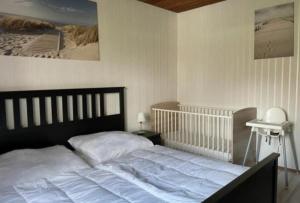 a bedroom with a large bed with white sheets at Ferienhaus Seestern in Dornum
