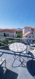 a table and two chairs on top of a roof at Ana i Marko in Vodice