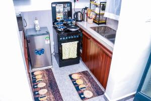 a kitchen with an open refrigerator with food inside at EnE Homes in Kisumu +10 photos