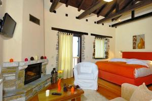 a bedroom with a bed and a fireplace at Prasino - Galazio in Mouresi